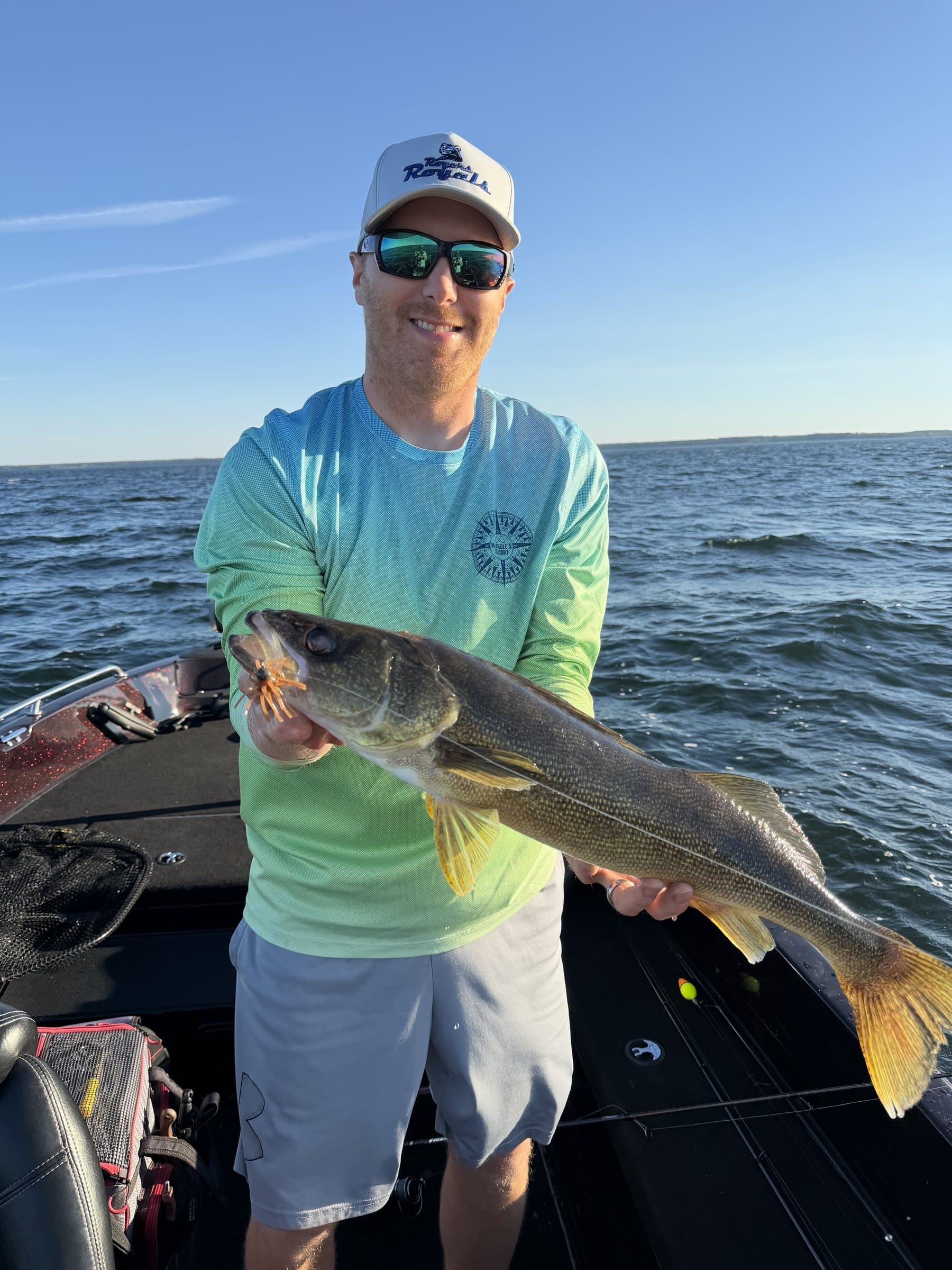 Angler on a boat holding a walleye caught on a Chapman Urchin bait