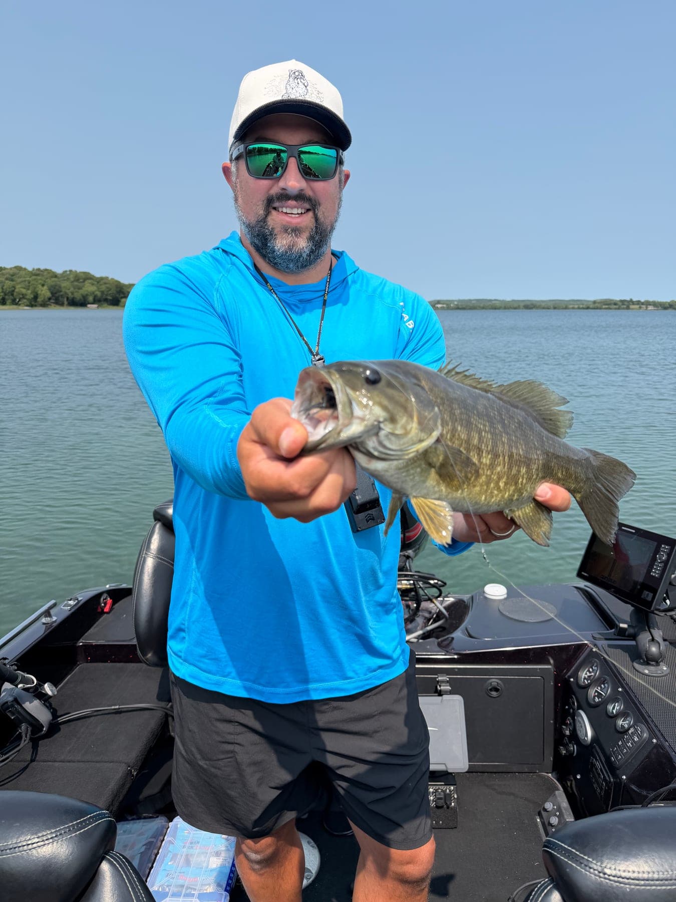 Angler holding a Smallmouth Bass from a day on the water